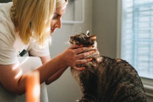 Woman cradling a cat